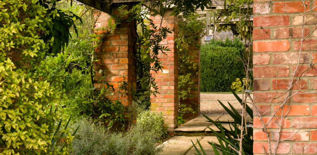 Grade II listed hall - Trellis with brick pillars